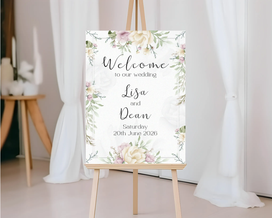 Wedding welcome sign with floral design on an easel against a white curtain background