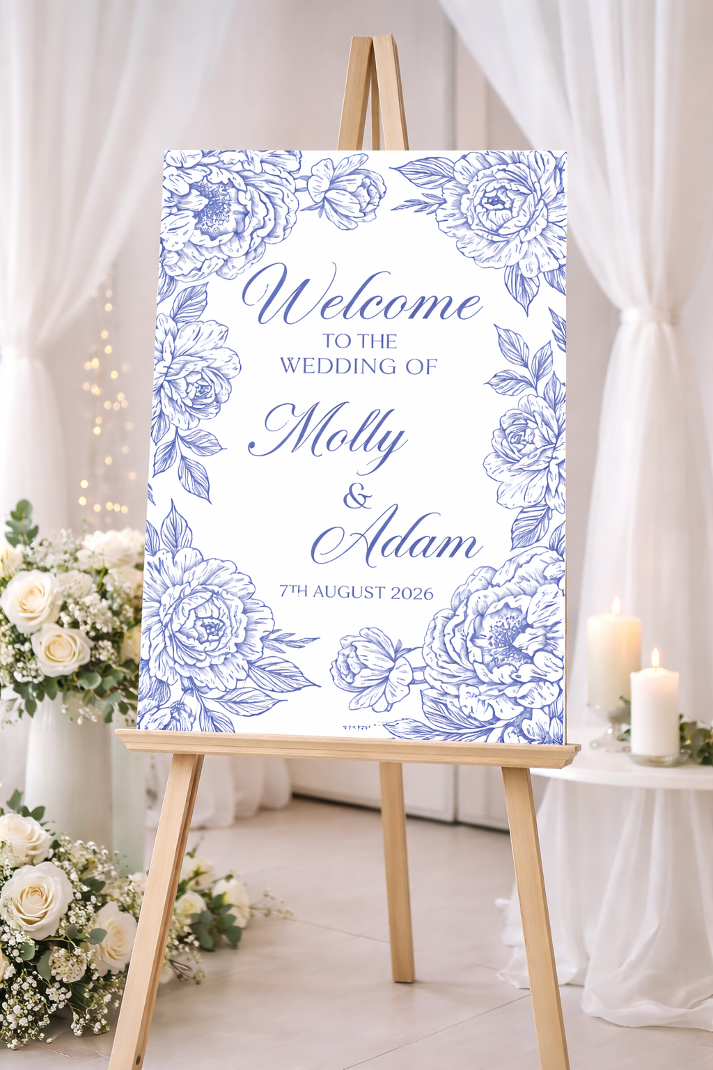 Wedding welcome sign with blue floral design on an easel