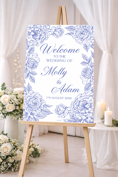 Wedding welcome sign with blue floral design on an easel